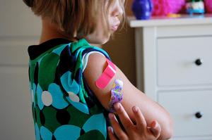 Image of child with bandages on her arm.